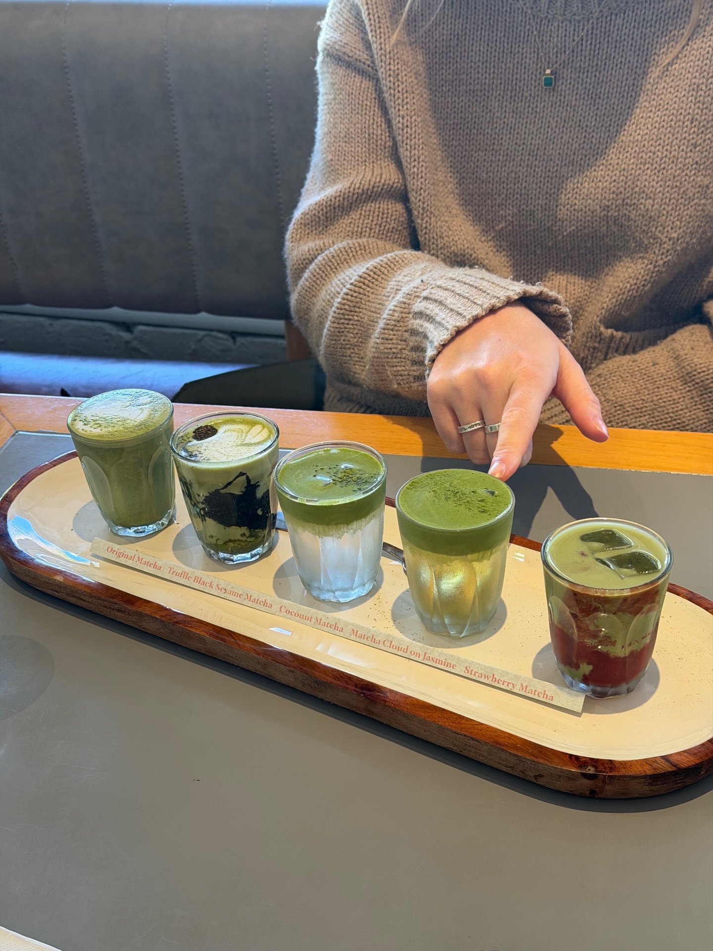 The winter matcha flight at The Wyatt in Gordon, Sydney — five piccolo-sized matchas (Original, Truffle Black Sesame, Coconut, Matcha Cloud on Jasmine and Strawberry) made with Kaizen matcha from Uji, served on a wooden tray.