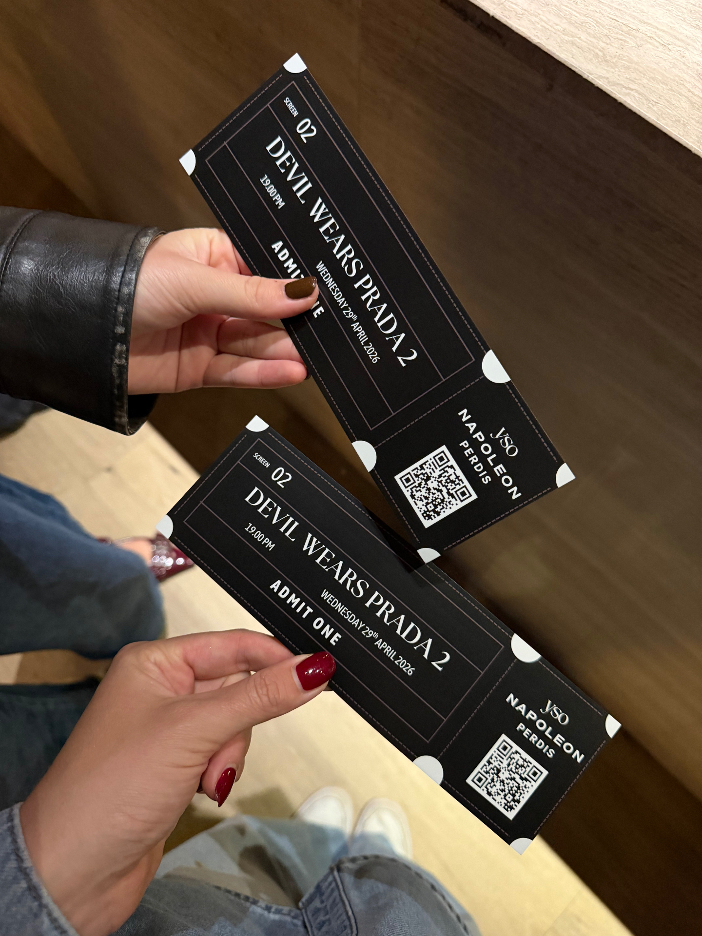 Two friends holding Devil Wears Prada 2 admit-one tickets co-branded with YSO and Napoleon Perdis at the Sydney premiere screening.