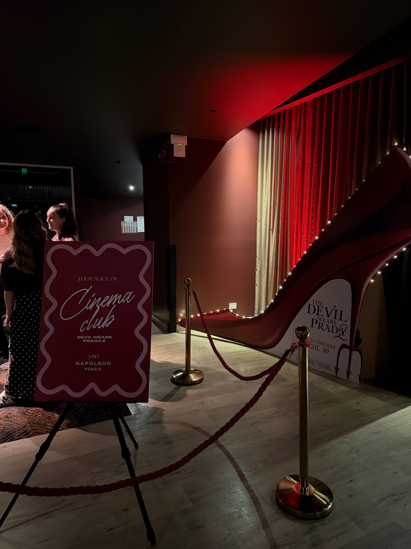 YSO Cinema Club signage on an easel beside a giant red stiletto Devil Wears Prada 2 cinema display at Event Cinemas Sydney.
