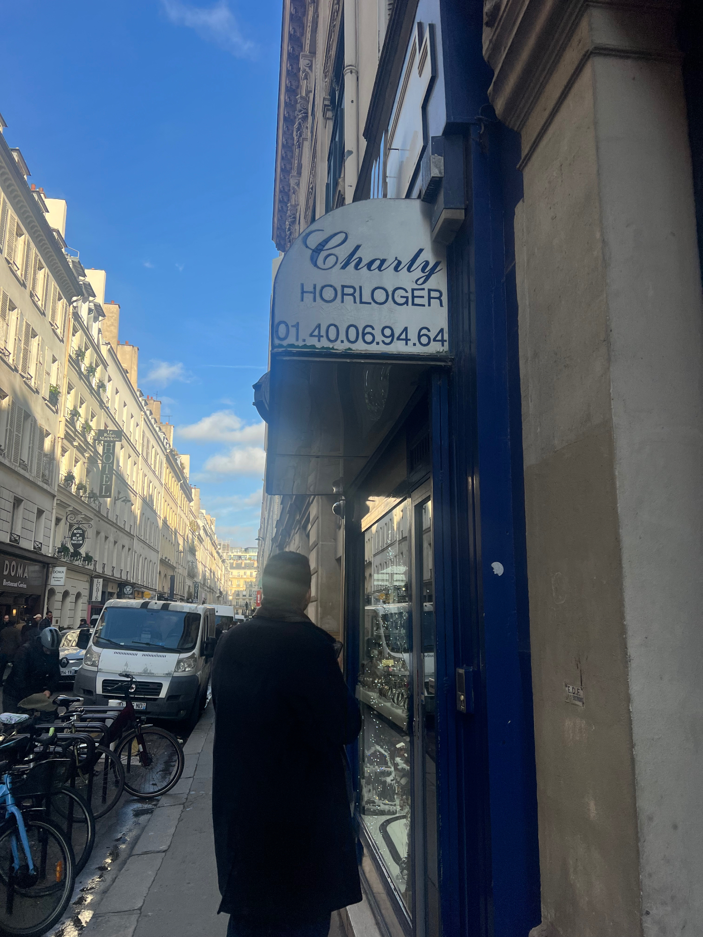 The blue-fronted Charly Horloger vintage watch shop on a sunny Paris side street near La Madeleine.